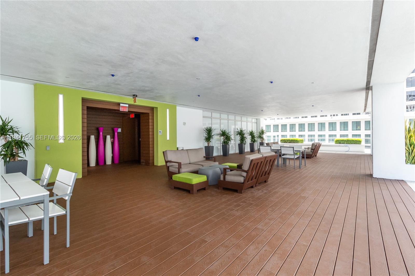 55 Southeast 6th Street, Unit 1202 Miami, FL 33131 - Photo 36 of 45 a living room with furniture and a wooden floor