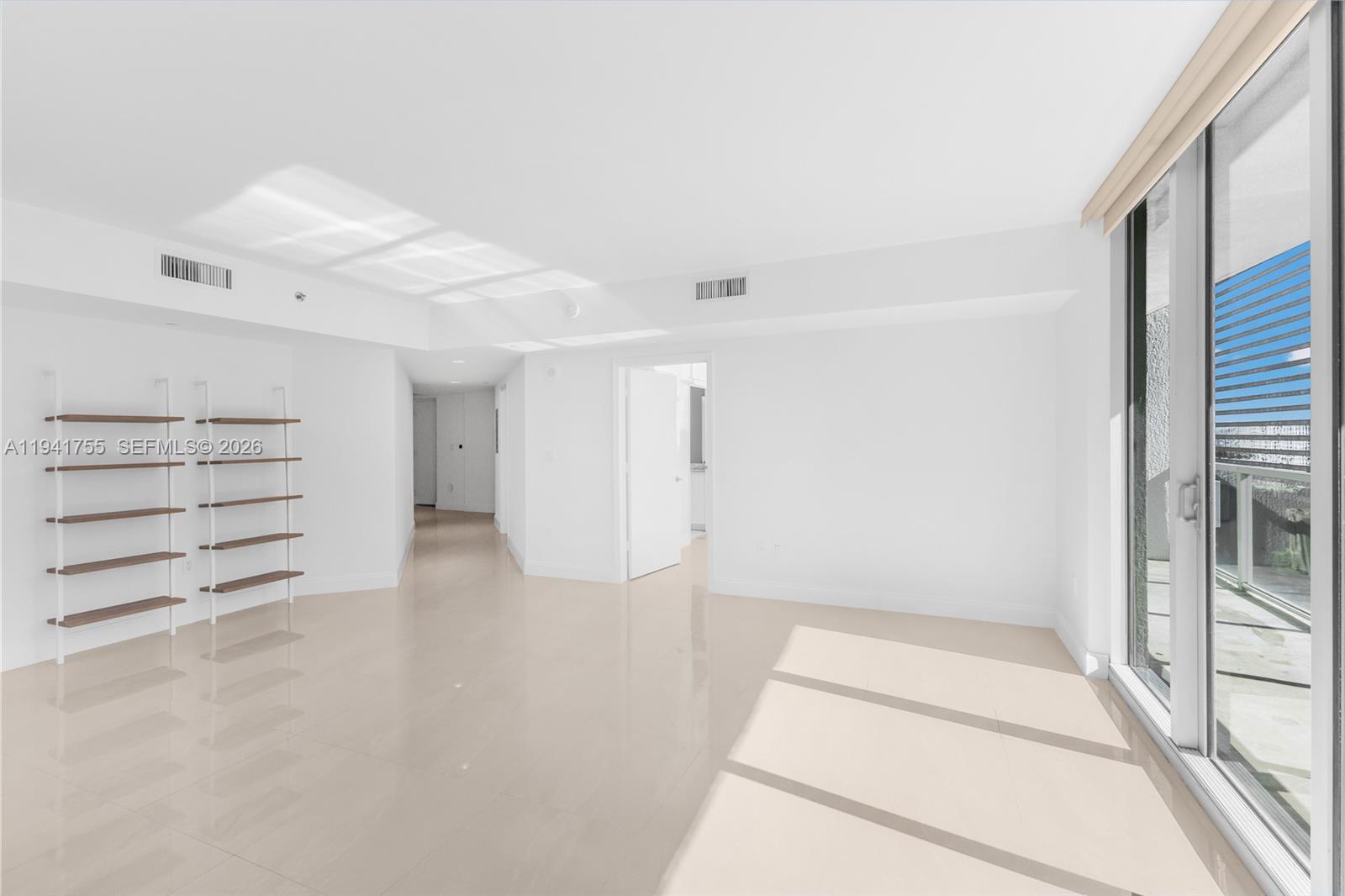 55 Southeast 6th Street, Unit 1202 Miami, FL 33131 - Photo 8 of 45 a view of empty room with wooden floor