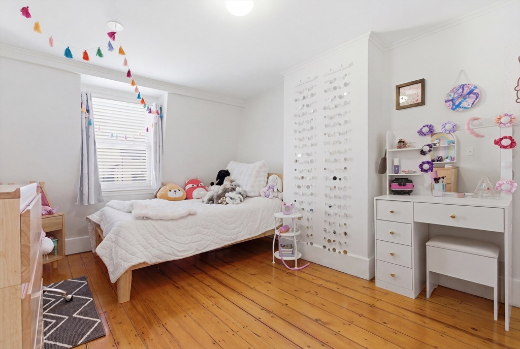 38 Bartlett Street Boston, MA 02129 - Photo 26 of 37 a bedroom with a bed and a dresser in it