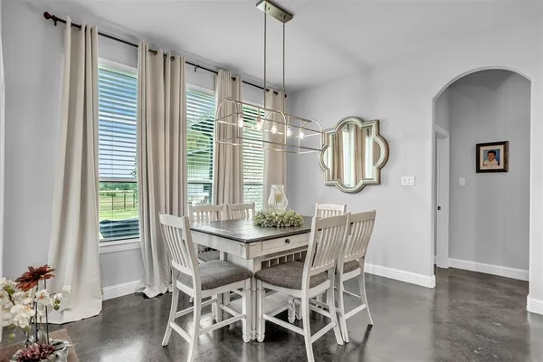 a kitchen with stainless steel appliances granite countertop a stove a sink dishwasher and cabinets with wooden floor