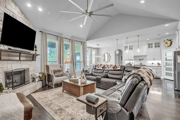 a dining room with furniture a chandelier and wooden floor