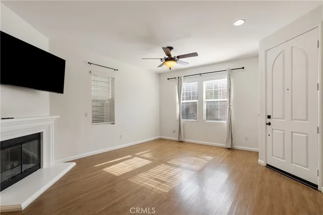 a view of livingroom with furniture fireplace and wooden floor