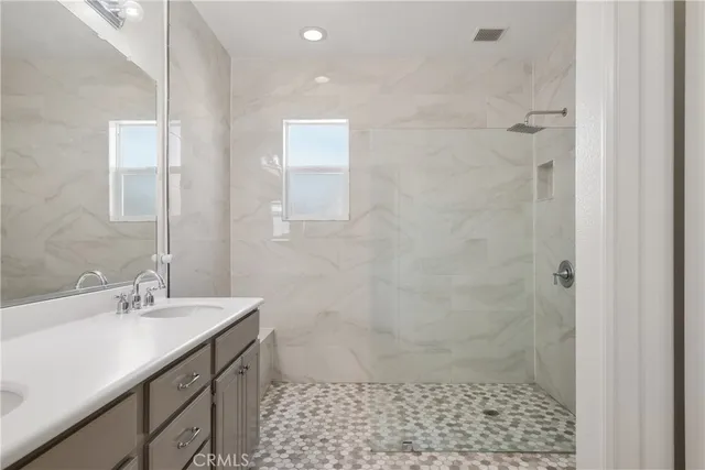 a bathroom with a sink a shower and a toilet