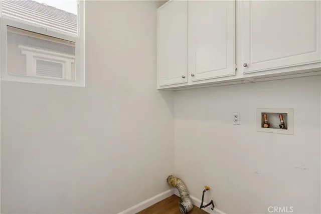 a view of a hallway with wooden floor and stairs
