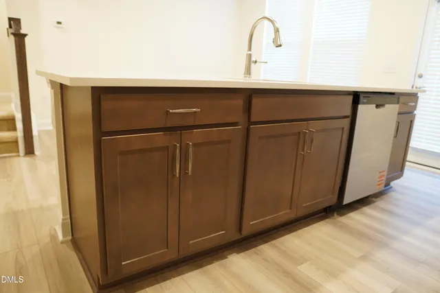 a close view of a sink and refrigerator