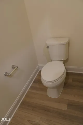 a white toilet sitting next to a shower