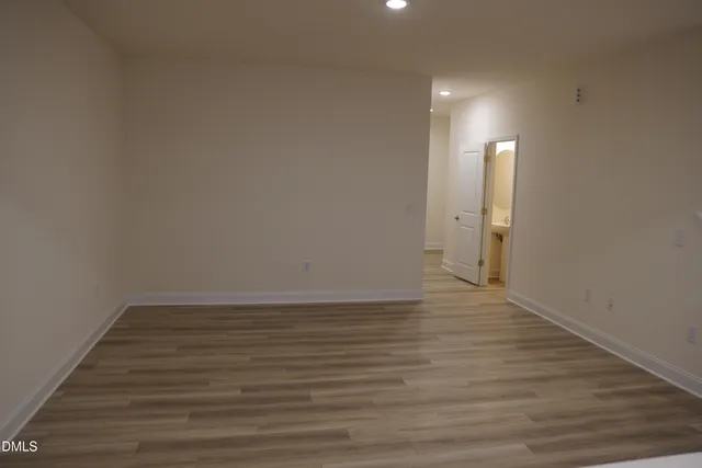a view of an empty room and wooden floor