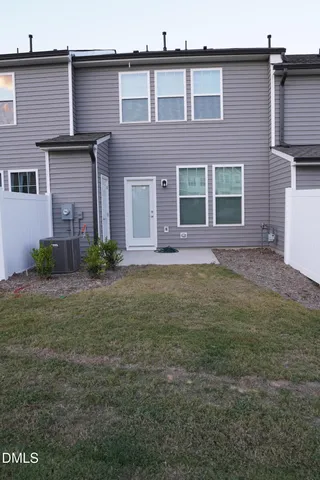 a front view of a house with a yard and outdoor seating