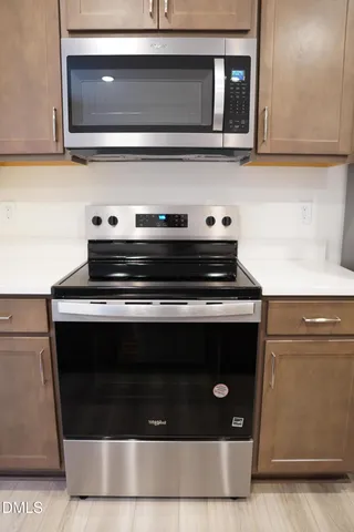 a stove top oven sitting inside of a kitchen