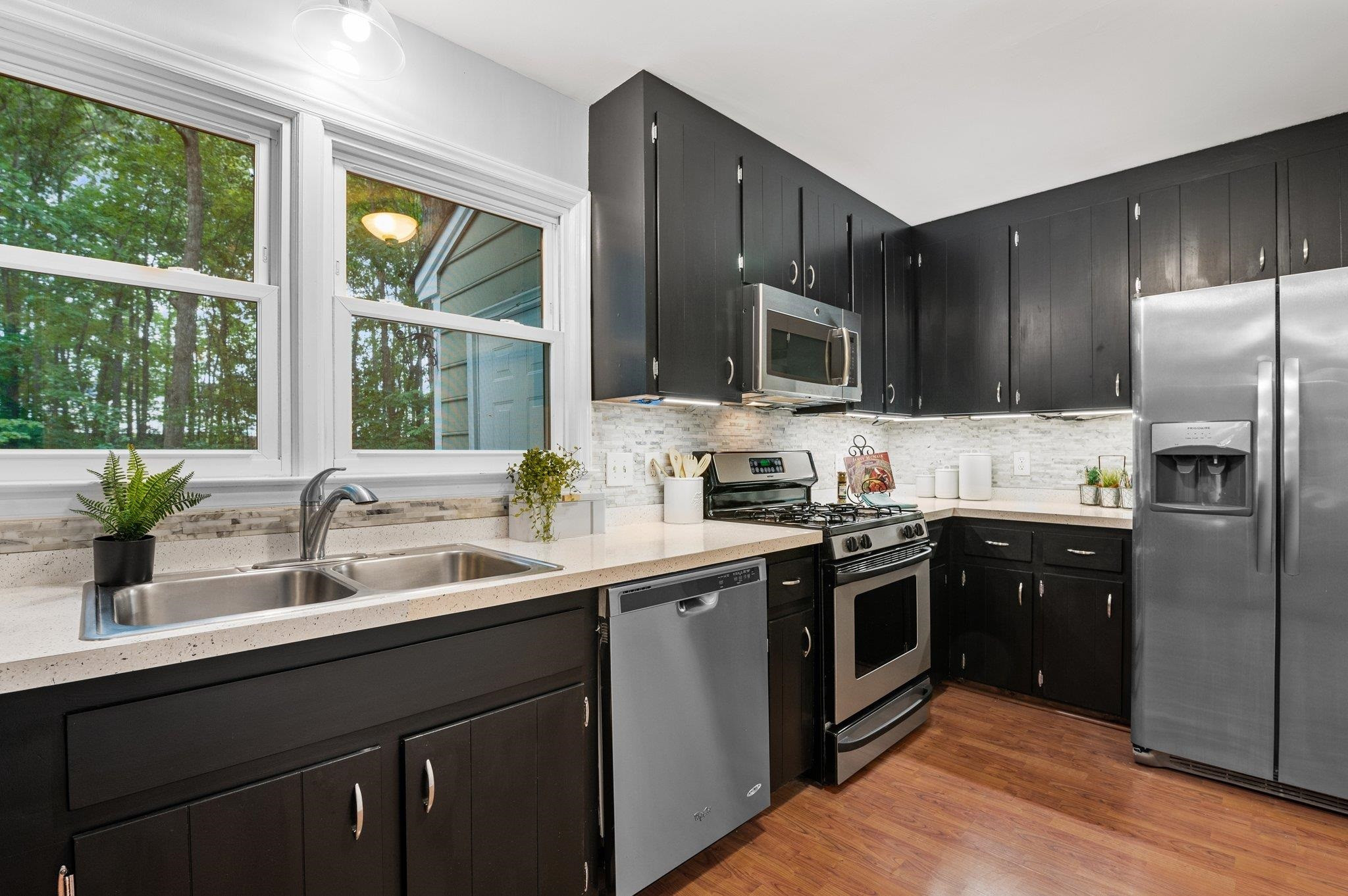 7818 Breckon Way Raleigh, NC 27615 - Photo 11 of 27 a kitchen with stainless steel appliances granite countertop a sink stove and refrigerator