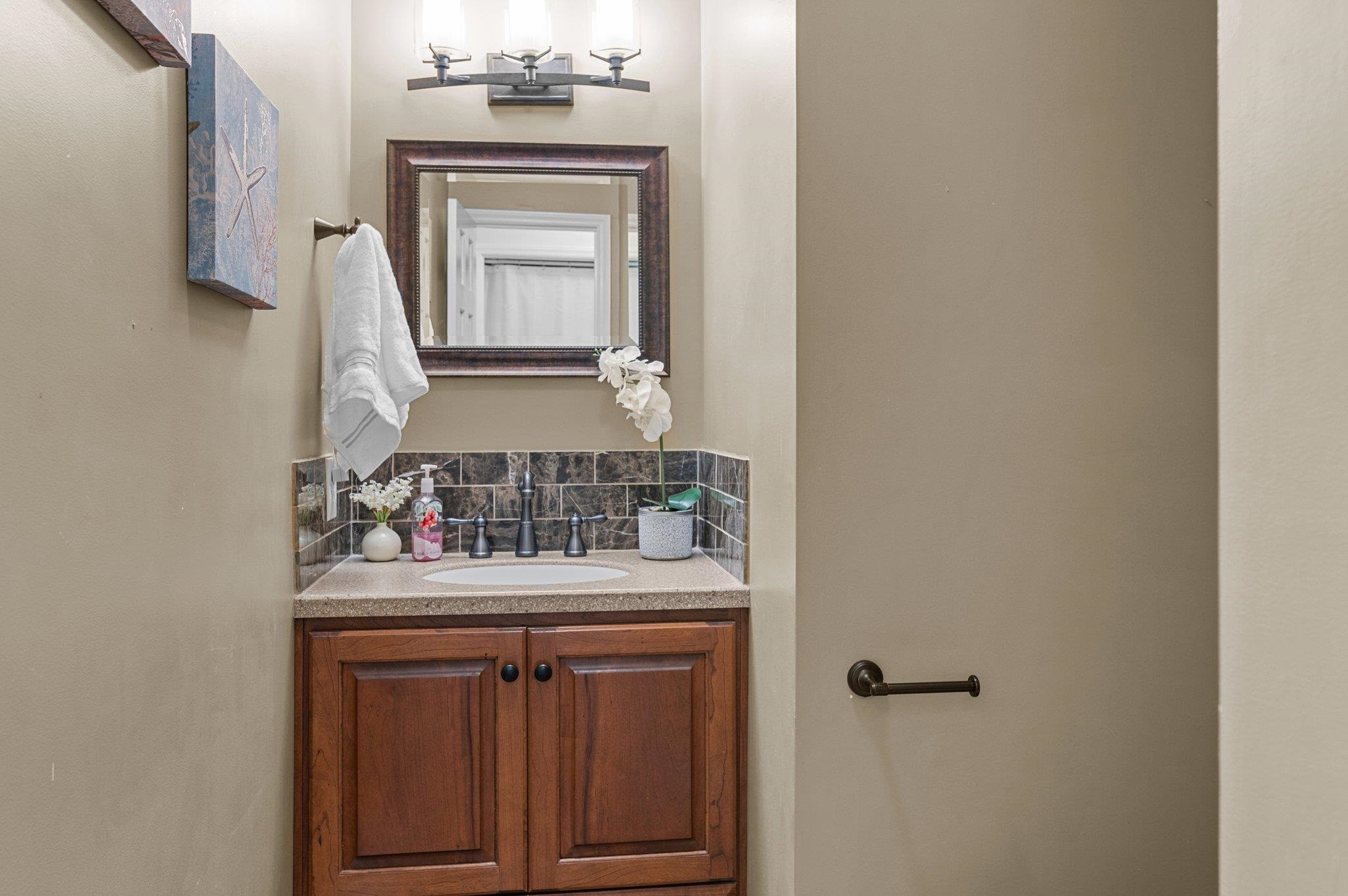 7818 Breckon Way Raleigh, NC 27615 - Photo 12 of 27 a bathroom with a sink vanity and a mirror
