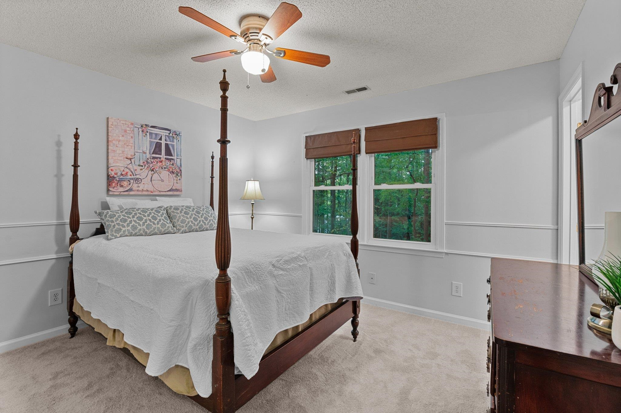 7818 Breckon Way Raleigh, NC 27615 - Photo 17 of 27 a bedroom with a bed and a window