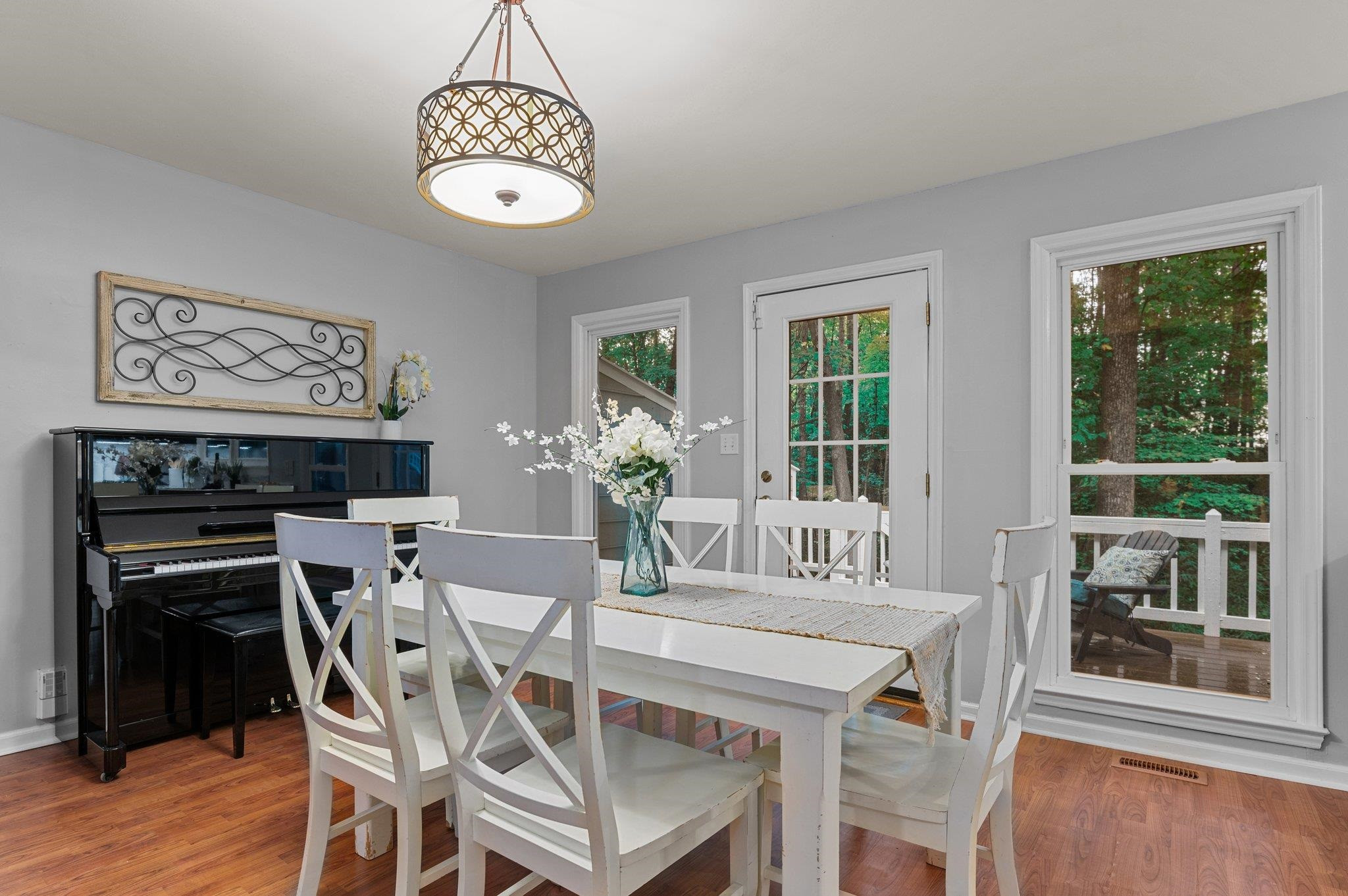 7818 Breckon Way Raleigh, NC 27615 - Photo 8 of 27 a dining room with furniture a chandelier and wooden floor