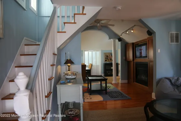 a living room with furniture and a chandelier