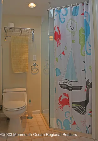 a bathroom with a toilet and a shower curtain