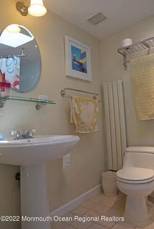 a bathroom with a toilet a sink and a mirror