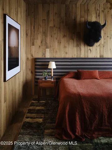 a bedroom with a bed and a mirror