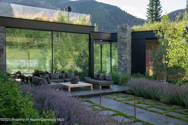 a view of a patio with furniture and garden