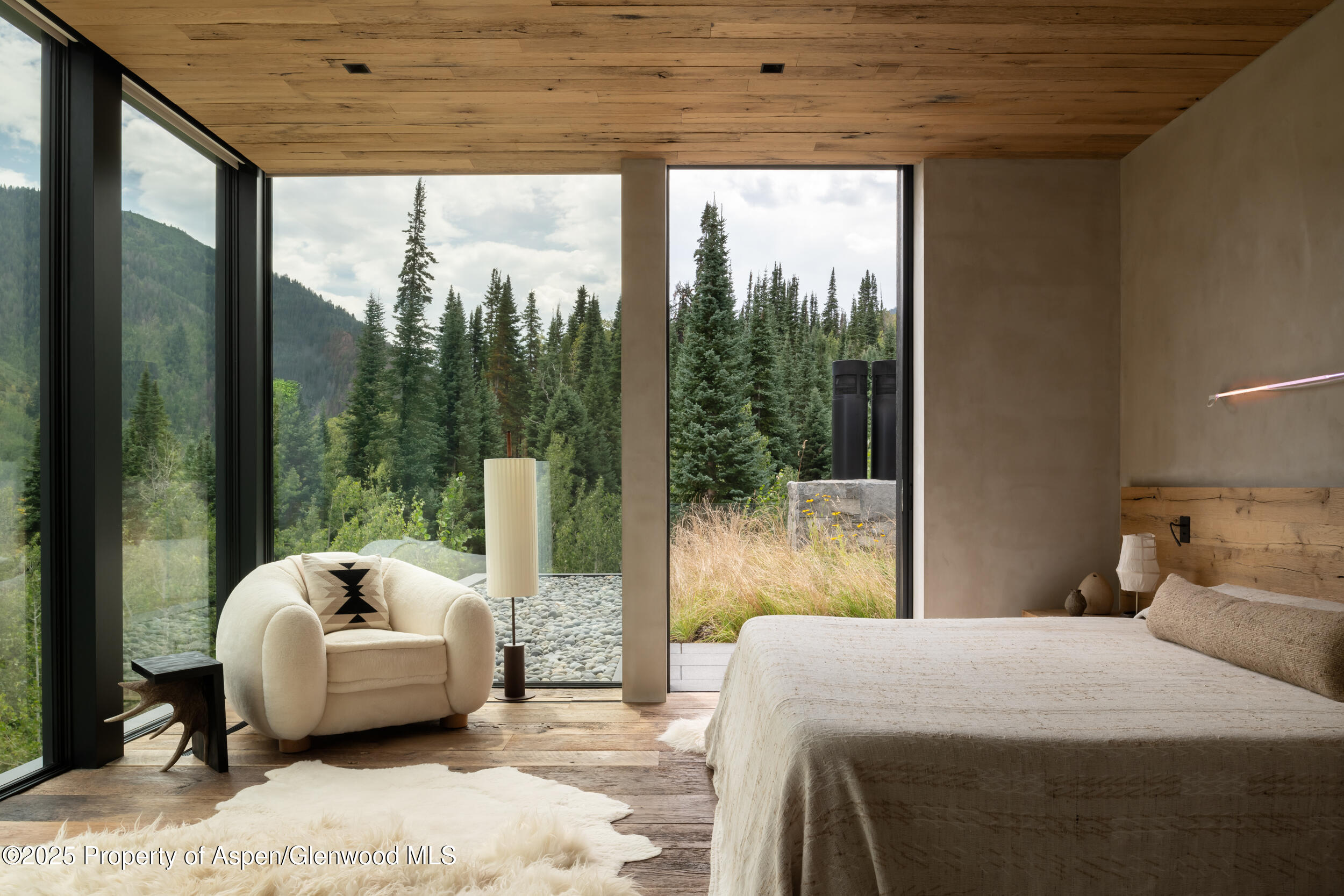724 North Hayden Road Aspen, CO 81611 - Photo 28 of 35 a bedroom with a bed and large window