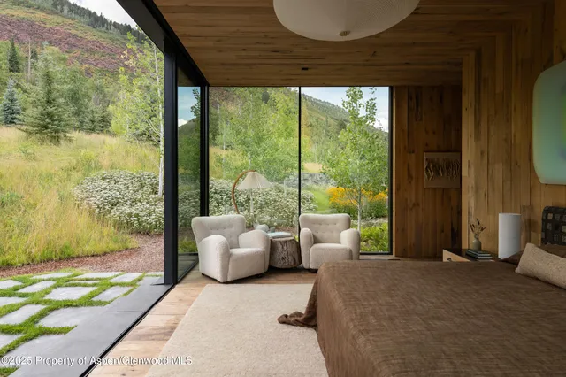 a bedroom with furniture and large windows