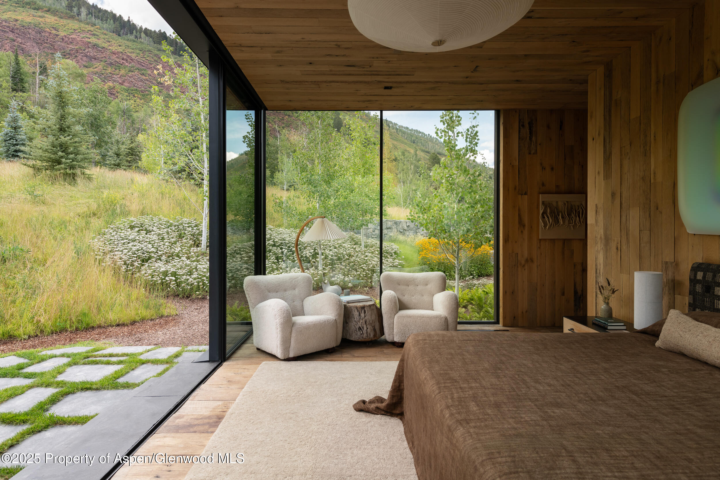 724 North Hayden Road Aspen, CO 81611 - Photo 30 of 35 a bedroom with furniture and large windows