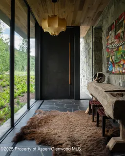 a living room with furniture a fireplace and a large window