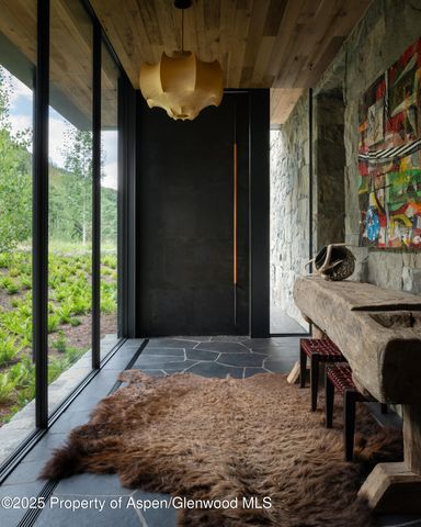 a living room with furniture a fireplace and a large window