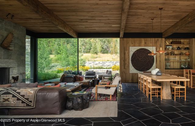 a living room with furniture a window and a fireplace