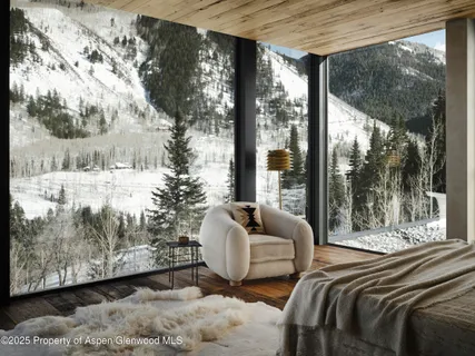 a bed sitting in a bedroom next to a large window