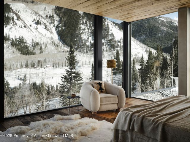 a bed sitting in a bedroom next to a large window