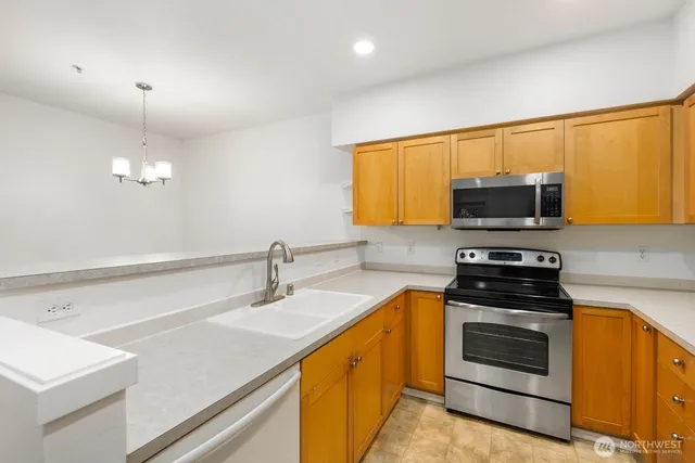 a kitchen with a sink stove and microwave