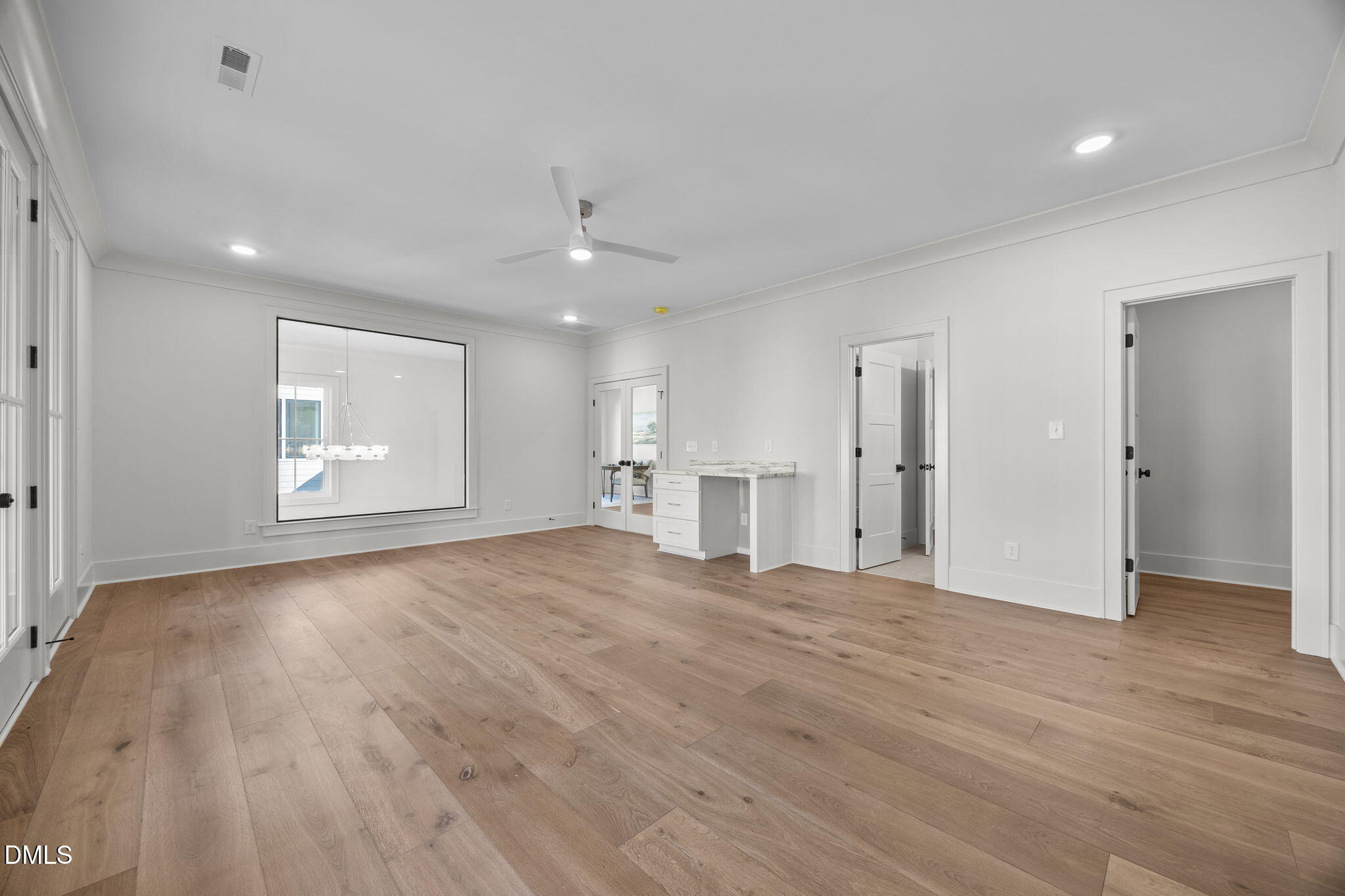 1000 Canterbury Road Raleigh, NC 27607 - Photo 25 of 46 a view of an empty room with wooden floor and kitchen space