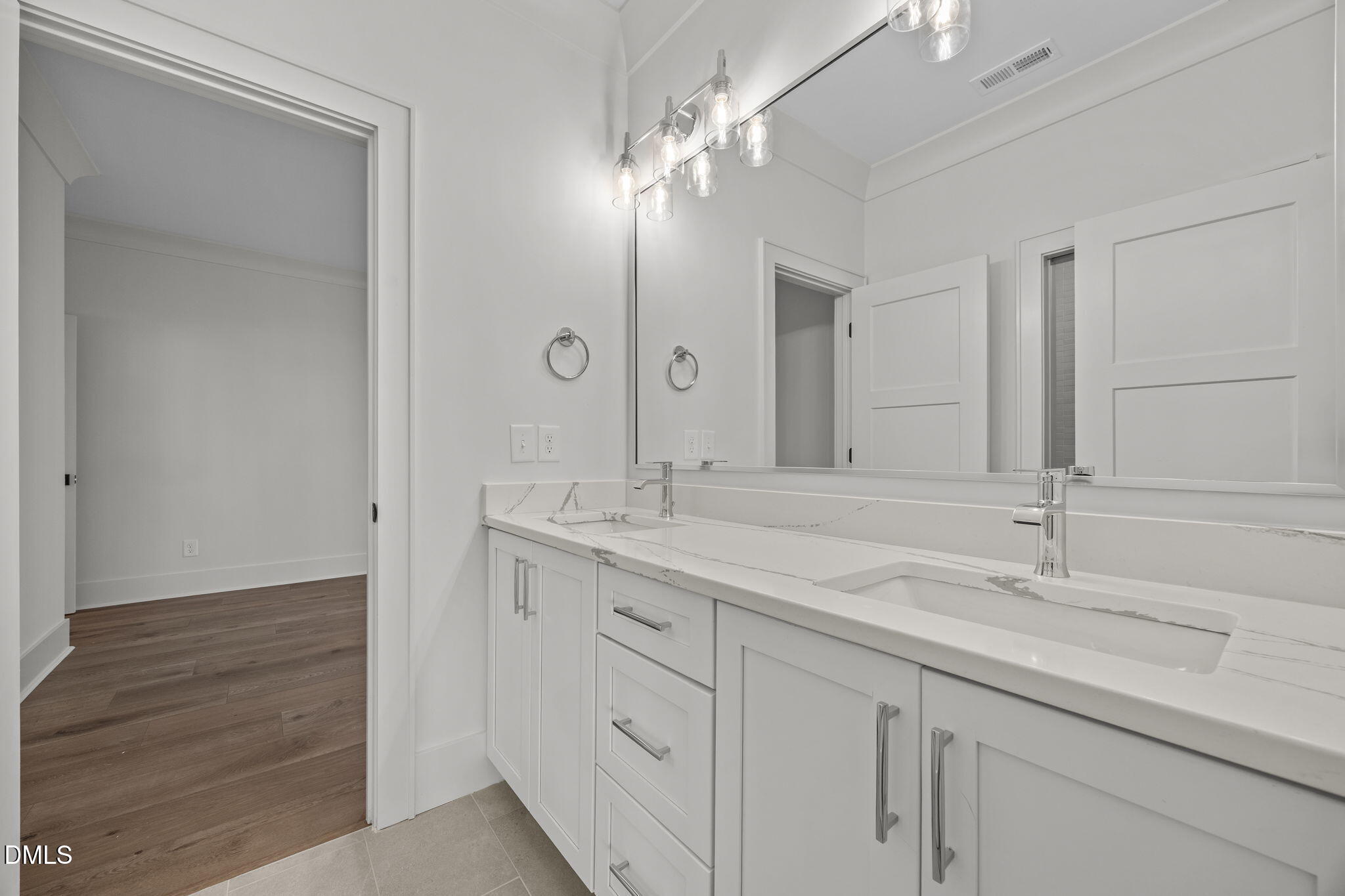 1000 Canterbury Road Raleigh, NC 27607 - Photo 26 of 46 a bathroom with a double vanity sink and a mirror