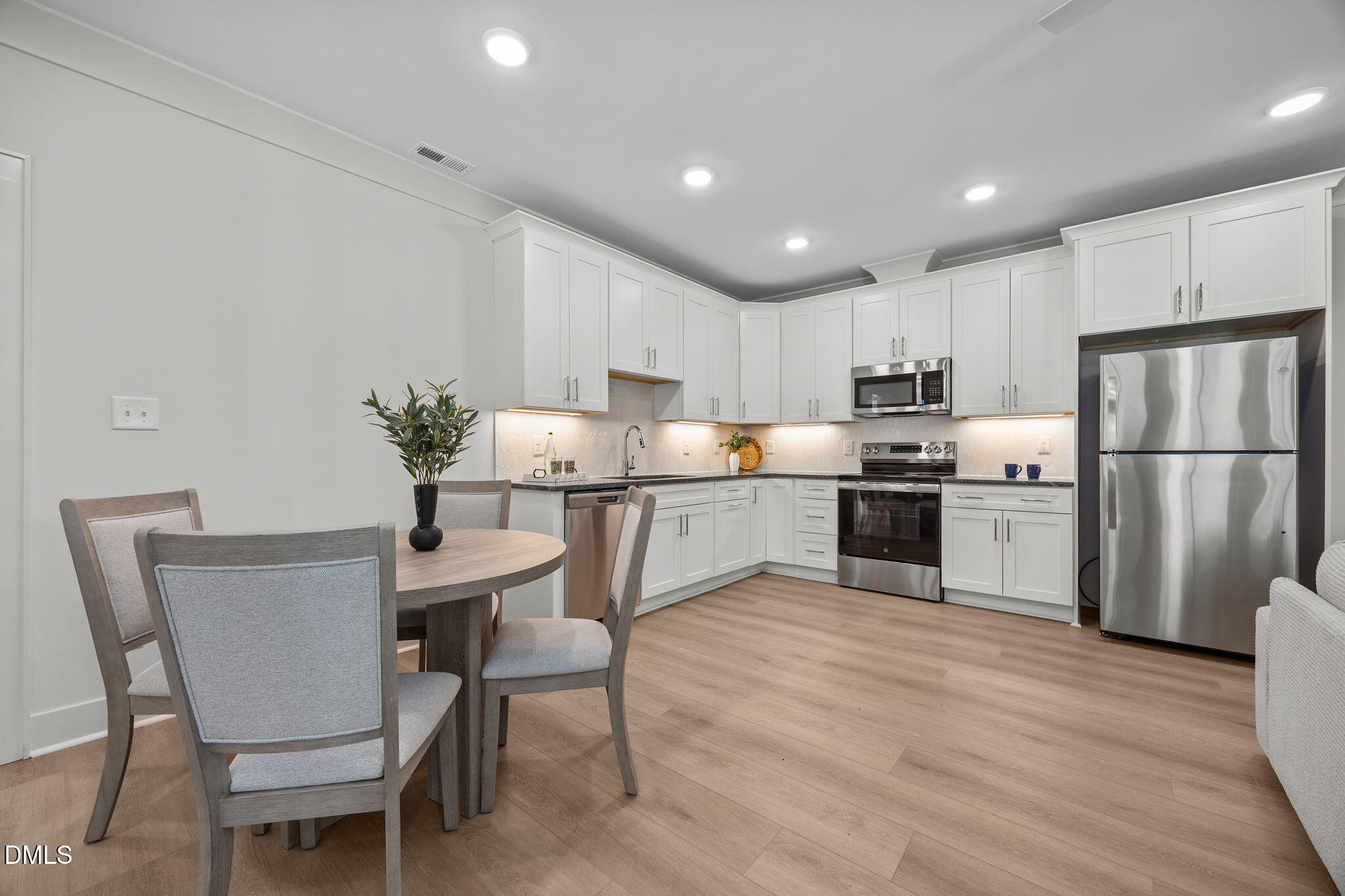 1000 Canterbury Road Raleigh, NC 27607 - Photo 31 of 46 a kitchen with granite countertop a center island stainless steel appliances cabinets and a center island