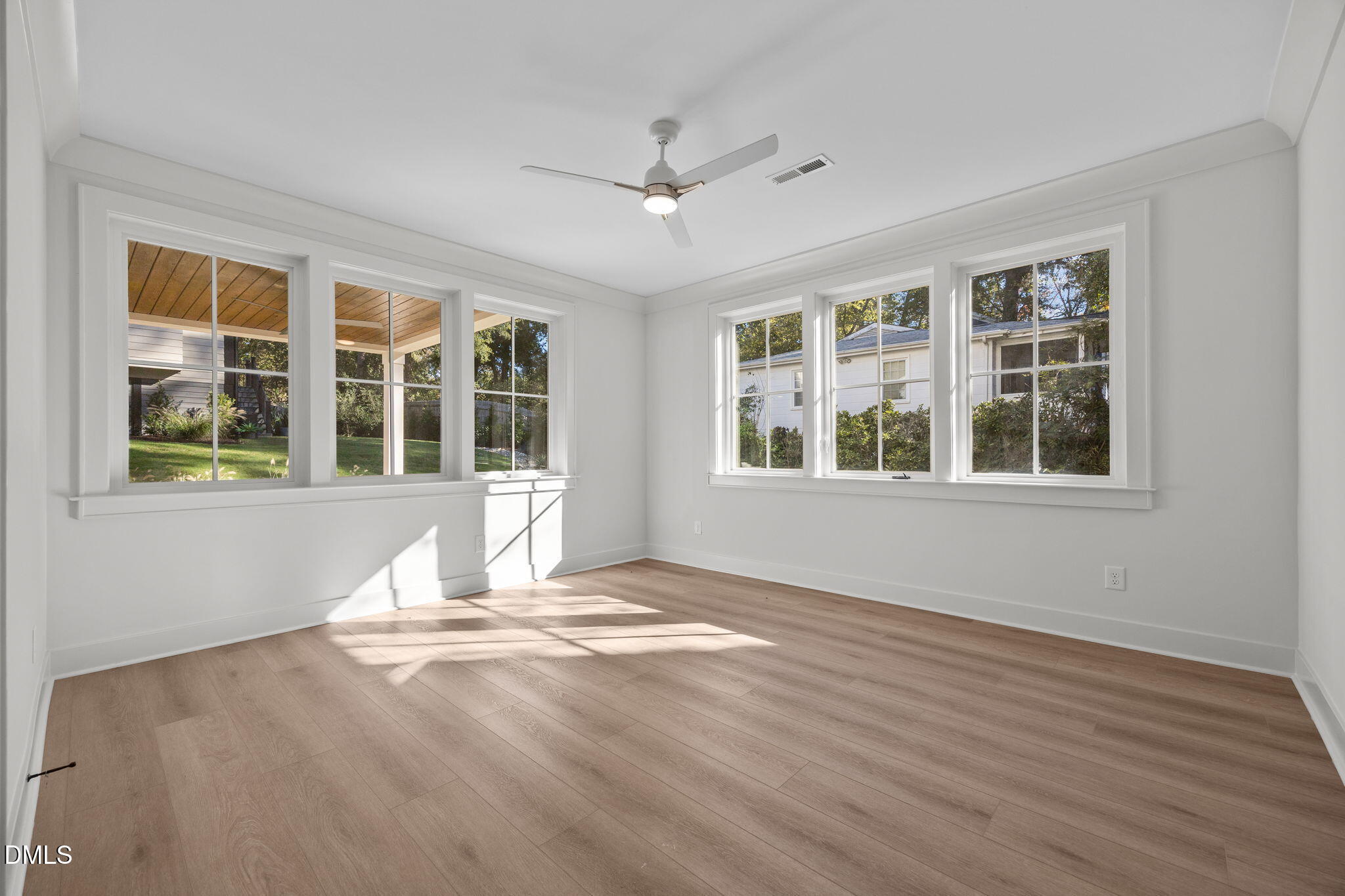 1000 Canterbury Road Raleigh, NC 27607 - Photo 34 of 46 a view of an empty room with wooden floor and windows