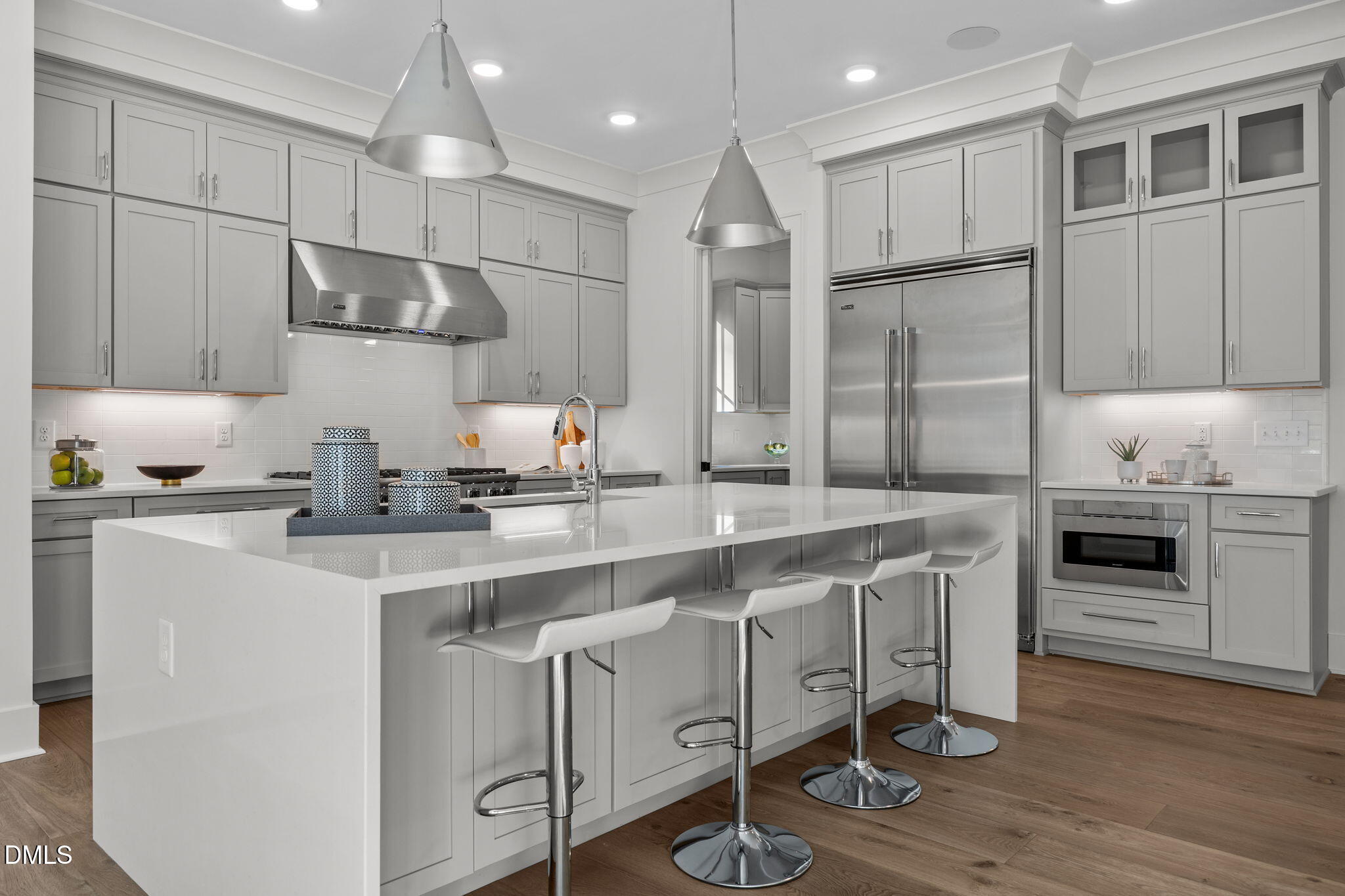 1000 Canterbury Road Raleigh, NC 27607 - Photo 5 of 46 a kitchen with stainless steel appliances granite countertop a sink a stove a refrigerator and island with wooden floor