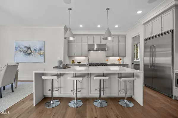 a kitchen with cabinets a counter space stainless steel appliances and wooden floor