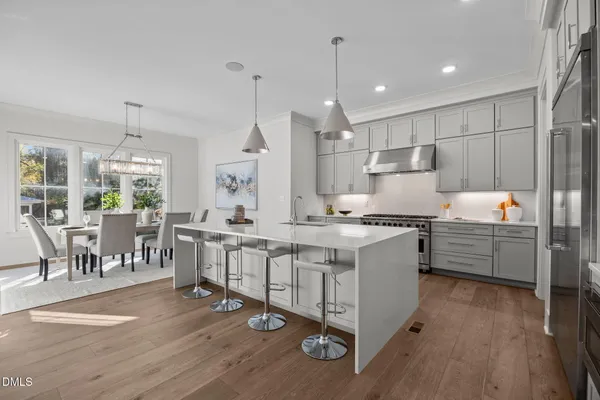 a living room with furniture a fireplace and a large window