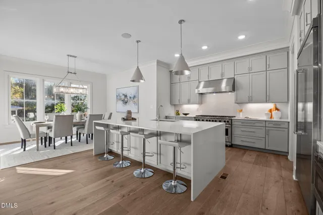 a living room with furniture a fireplace and a large window