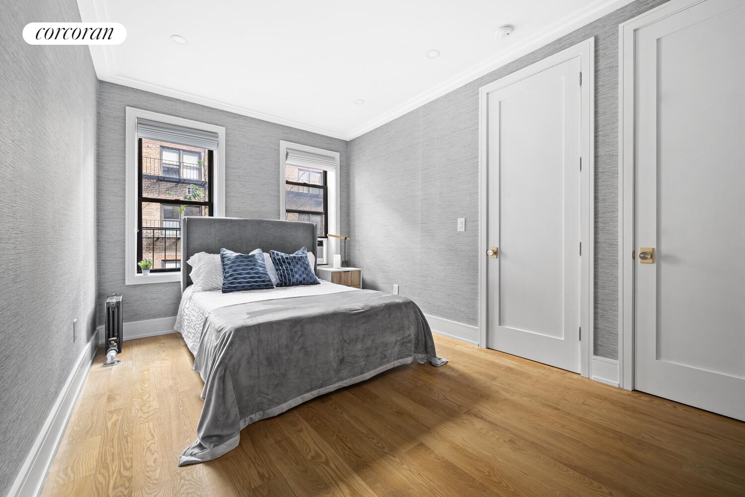 325 East 80th Street, Unit 4H Manhattan, NY 10075 - Photo 3 of 7 a bedroom with a bed and a window