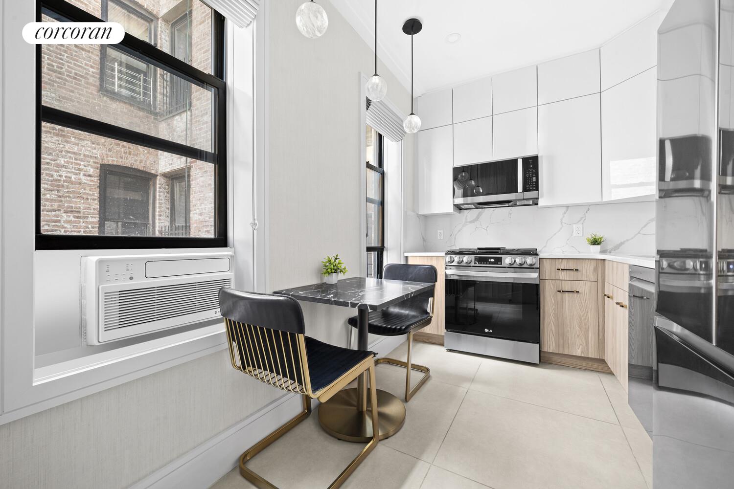 325 East 80th Street, Unit 4H Manhattan, NY 10075 - Photo 4 of 7 a kitchen with stainless steel appliances a stove a sink and a microwave
