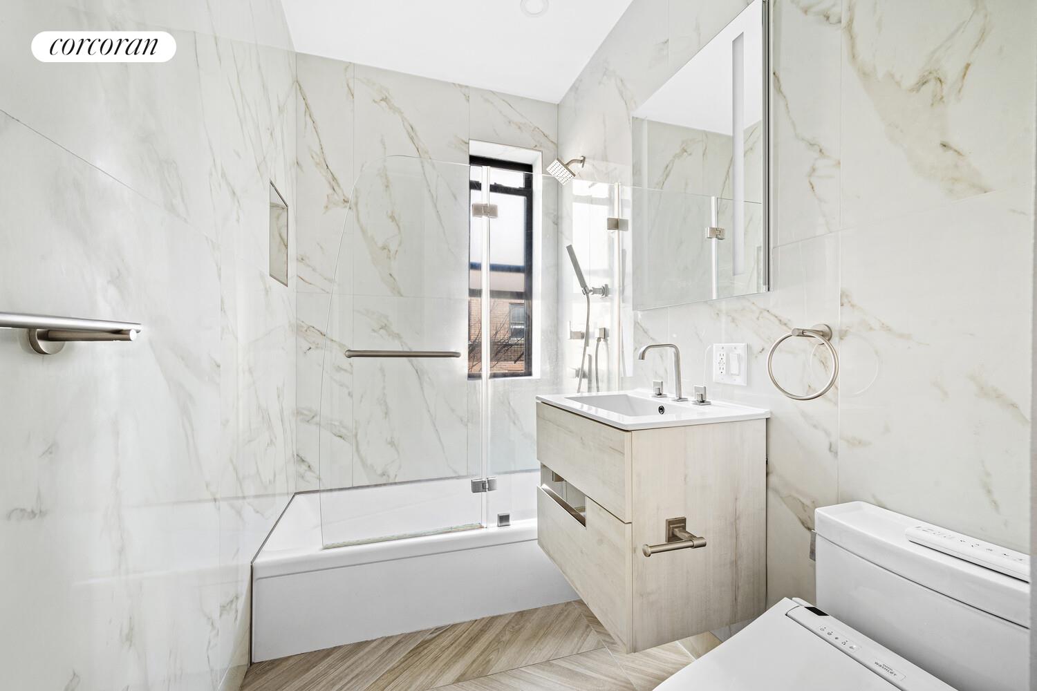 325 East 80th Street, Unit 4H Manhattan, NY 10075 - Photo 5 of 7 a bathroom with a sink a toilet and a bathtub