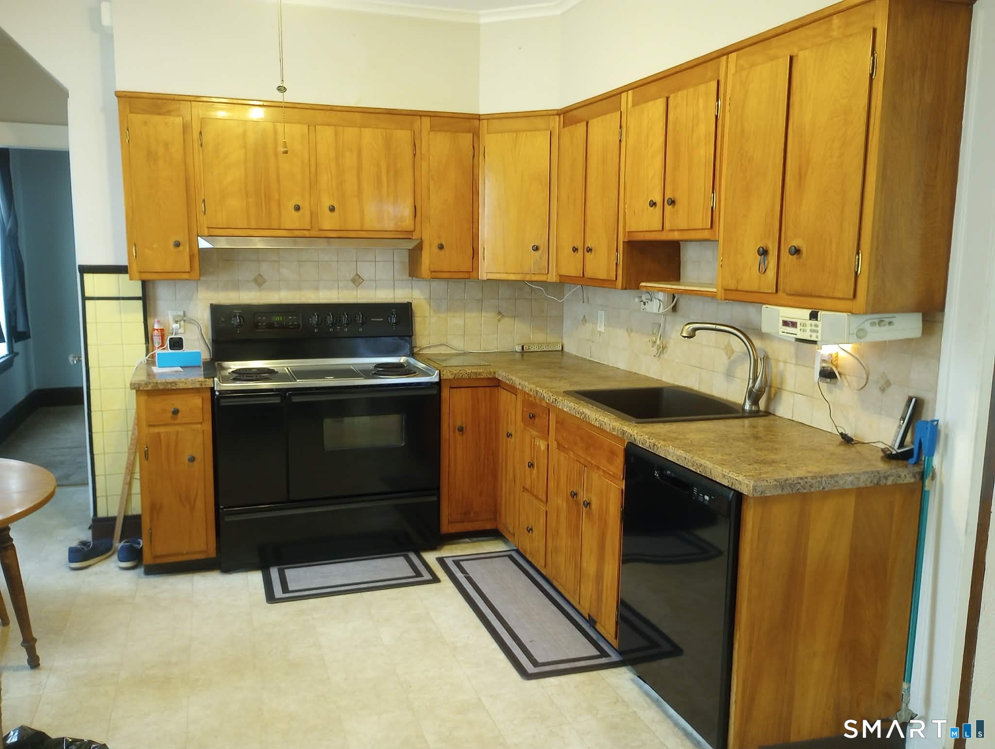 64 Moody Avenue Fairfield, CT 06825 - Photo 4 of 38 a kitchen with a sink stove and cabinets