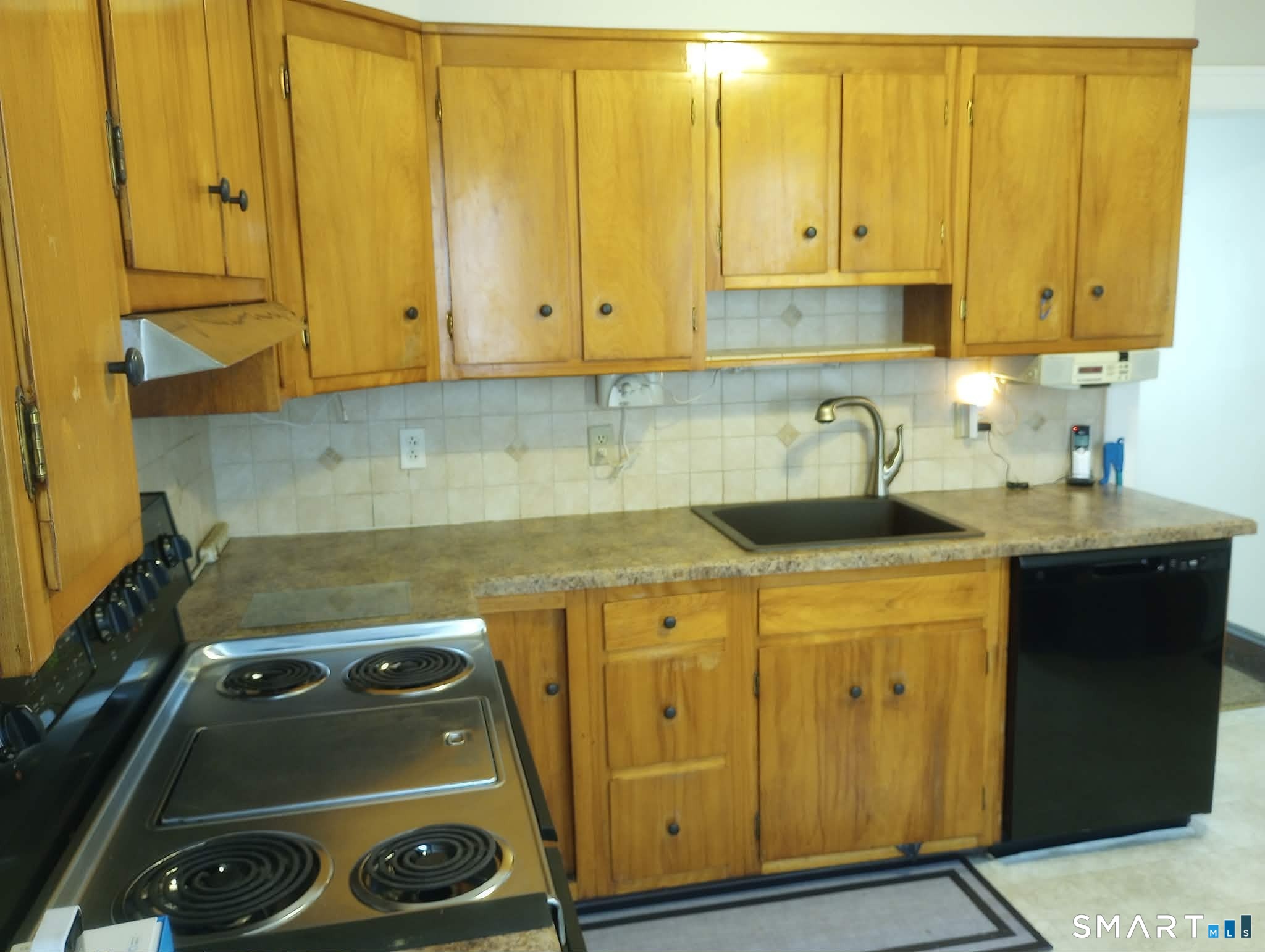 64 Moody Avenue Fairfield, CT 06825 - Photo 5 of 38 a kitchen with a sink and cabinets