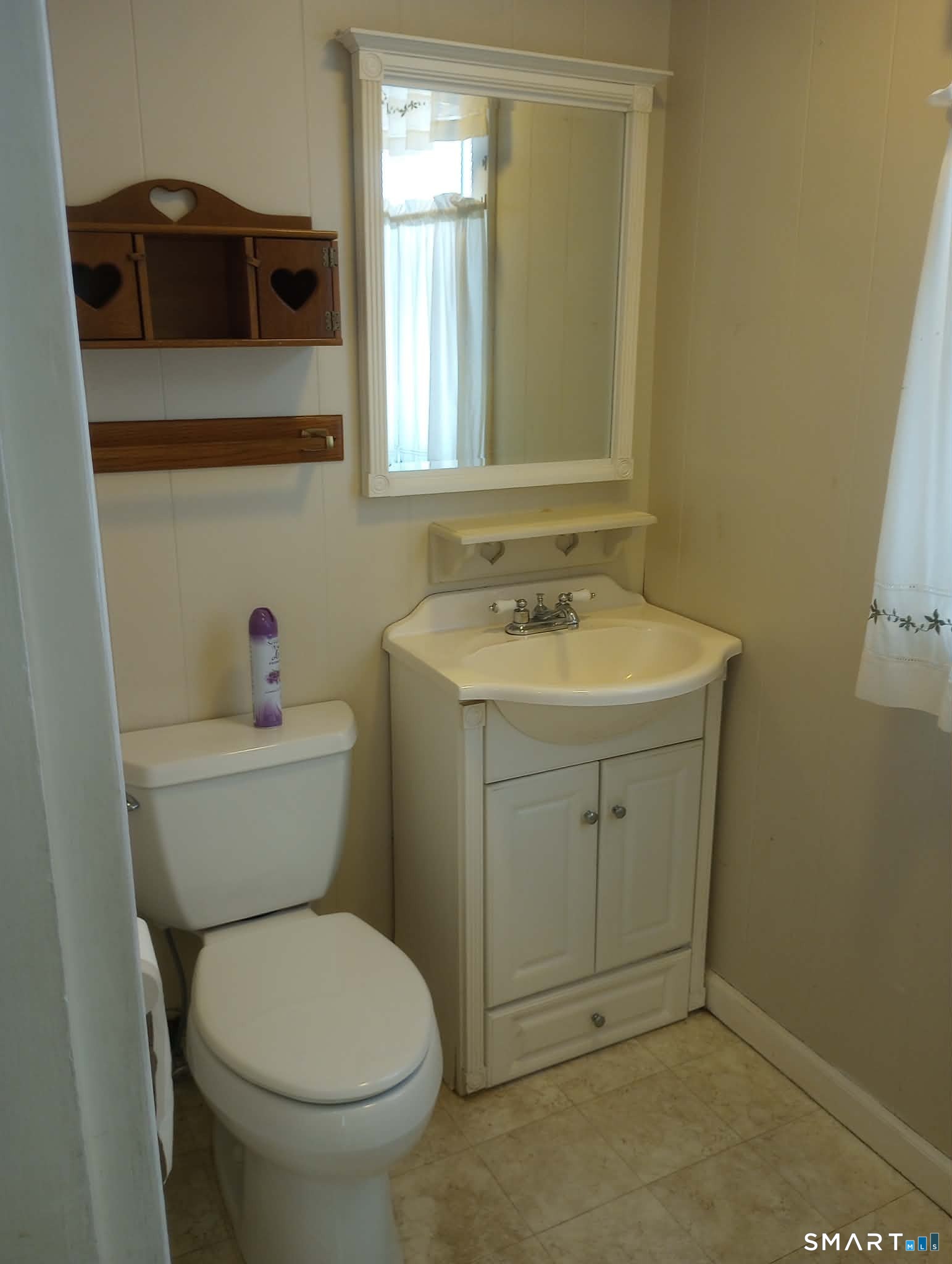 64 Moody Avenue Fairfield, CT 06825 - Photo 6 of 38 a bathroom with a toilet sink and mirror