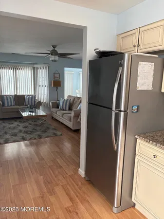 a kitchen with stainless steel appliances granite countertop a refrigerator and a stove