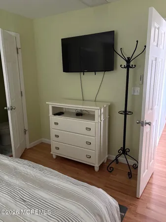 a bed room with a bed and a flat screen tv