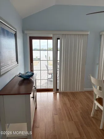 a view of a room with wooden floor and a window