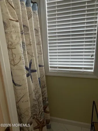 a bathroom with a shower and a sink