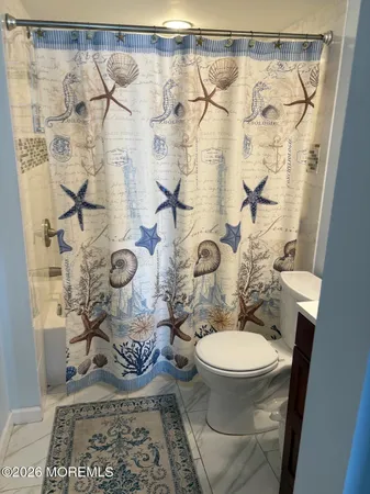 a bathroom with a toilet and a shower